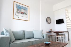 a living room with a blue couch and a table at The Ioulis Pool in Ioulis