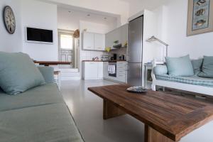 a living room with a couch and a wooden table at The Ioulis Pool in Ioulis