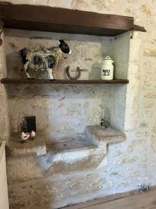 a stone wall with shelves with a cow on it at Poitevins in Saint-Astier +76 photos