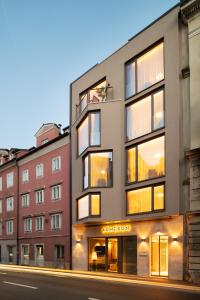 an apartment building on a city street at night at Armerun Hotel Rijeka in Rijeka