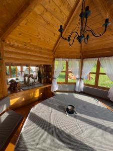 a bedroom with a large bed in a room with windows at Domek pod Królowem in Ustroń