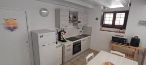 a kitchen with a white refrigerator and a sink at MaraSal in Pozzallo