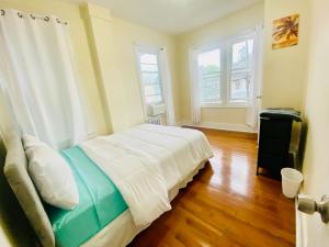 a bedroom with a bed and two windows at CaneView Properties - 1 in Irvington