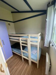 two bunk beds in a room with a ceiling at Camping 3 étoiles - Piscine - ccbgaia in Châtel-Chéhéry