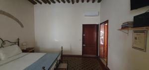 a bedroom with a bed and a wooden door at Sulla via Francigena in Fucecchio