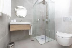 a bathroom with a shower and a toilet and a sink at Santa Barbara Residences by IDILIQ in Fuengirola