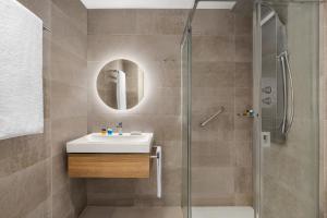 a bathroom with a sink and a shower at Santa Barbara Residences by IDILIQ in Fuengirola