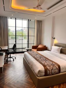 a hotel room with a large bed and a desk at The Koi Boutique Hotel in Gurgaon