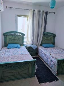 two beds sitting next to each other in a bedroom at Marina Blu Blumar Chalet in Ain Sokhna +19 photos
