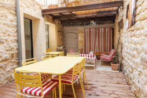 a yellow table and chairs on a patio at Plumard in Arles