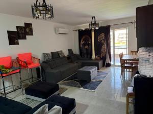 a living room with a couch and a table at Marina Blu Blumar Chalet in Ain Sokhna
