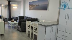 a living room with a couch and a table at ESTUDIOS CHINASOL - Bernardo Cózar in Almuñécar