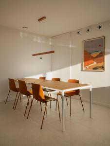 a dining room table and chairs in a room at Almar Suites Daimús in Daimuz +16 photos