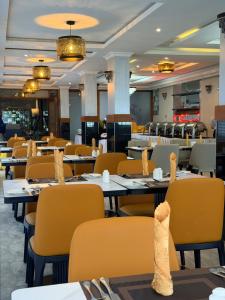 an empty restaurant with tables and chairs with their food at Yeza Garden Hotel in Nairobi