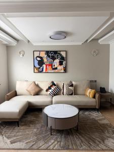 a living room with a couch and a coffee table at Yeza Garden Hotel in Nairobi
