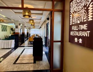 a lobby of a restaurant with a sign on the wall at Yeza Garden Hotel in Nairobi