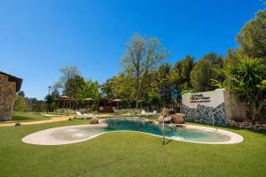 a swimming pool in a yard with a slide at Kampaoh Fonts d' Algar in Callosa d'en Sarrià