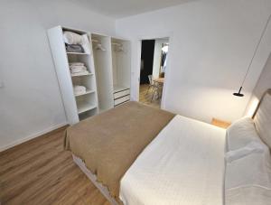 a white bedroom with a bed and a closet at BR Silgar Club in Sanxenxo