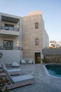 a house with a patio and a swimming pool at Lithos Luxury Suites in Tinos