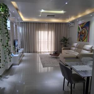 a living room with a couch and a table at Espaço Acolhedor in Luanda