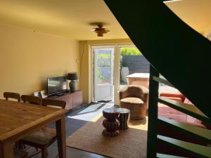 a living room with a table and a television at Hotel Domburg4you in Domburg