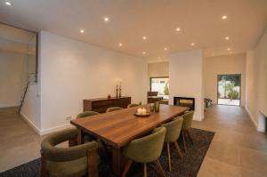 a dining room with a wooden table and chairs at Villa Bazaruto in Lagos