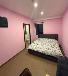 a bedroom with a bed and a pink wall at Bernotiškių Hotel & Dining in Stotis Bernotiškis