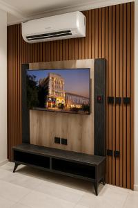 a flat screen tv sitting on top of a wall at لحظات للشقق المخدومة in Jeddah
