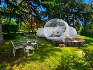 a iguana house in a field with a table and chairs at FUGA ROMANTICA - Panoramica in Almese