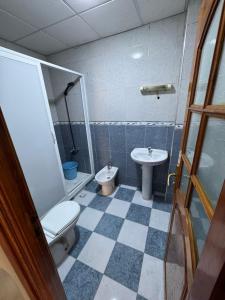 a bathroom with a toilet and a sink at Larache City Apartment in Larache