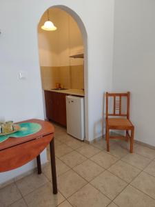 a kitchen with a table and a chair in a room at Deilino - Sunset Studio in Amorgos