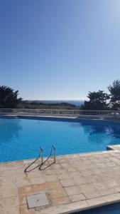una gran piscina de agua azul claro en Ikaria Village , apartment 202 en Pafos
