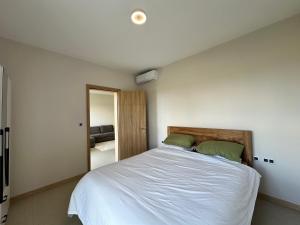 a bedroom with a large white bed and a mirror at Haven Suites in Moka +20 photos
