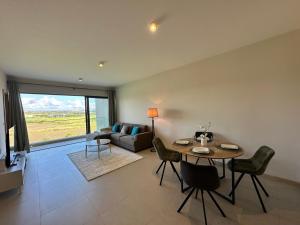 a living room with a table and a couch at Haven Suites in Moka