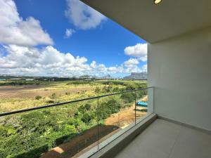 a balcony with a view of a field at Haven Suites in Moka