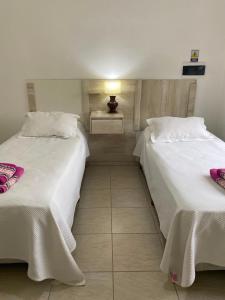 two beds sitting next to each other in a room at Heart Viedma in Viedma