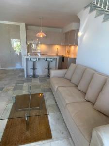 a living room with a couch and a kitchen at Marbella Sunseat apartment in Marbella