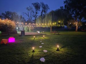 a park with candles in the grass at night at Domaine de la Besnerie Gites avec SPA Privatif à 10 min du Mont St Michel in Tanis