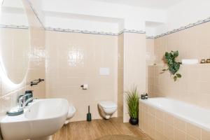 a bathroom with a sink and a toilet and a tub at Dimore Abruzzo - Borgo 27 in Celano +34 photos
