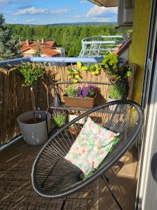 a bench on a balcony with a pillow on it at SilvaBlau Apartment Hévíz in Hévíz +4 photos