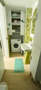 a bathroom with a sink and a washing machine at Mama's Home in Chios +61 photos