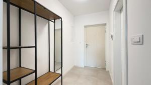 a room with a glass shelf and a hallway at Salt Oasis Apartment Tuzla in Tuzla