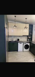 a kitchen with a refrigerator and a dishwasher at NikO's Stay in Mestia +26 photos