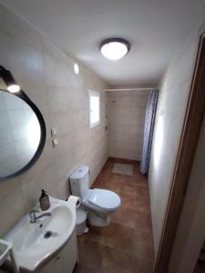 a bathroom with a toilet and a sink and a mirror at Pokoje Gościnne u DORIS in Stegna +17 photos