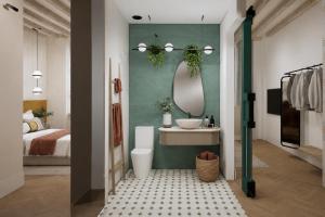 a bathroom with a bed and a sink and a mirror at Hotel Casa Beatas in Málaga