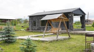 a wooden swing in front of a cabin at Jermuk gaden in Kechʼut