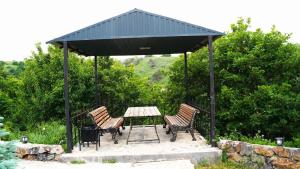 a gazebo with a table and chairs under it at Jermuk gaden in Kechʼut +5 photos