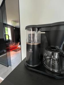 a black blender sitting on a counter in a kitchen at Jolster SPA apartments for 2 in Skei