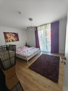 a bedroom with a bed and a window with purple curtains at Zeitlos in Stutensee