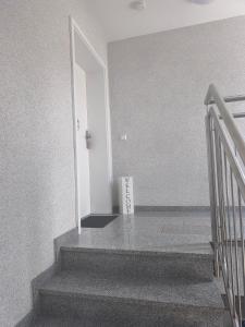 a box sitting on the floor next to a staircase at Zeitlos in Stutensee